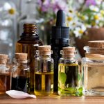 Selection of essential oils with herbs and flowers